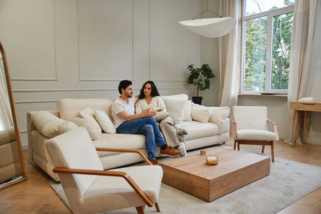 Couple relaxing on a modern cream sectional sofa in a bright, minimalist living room — luxury furniture Berks County PA.