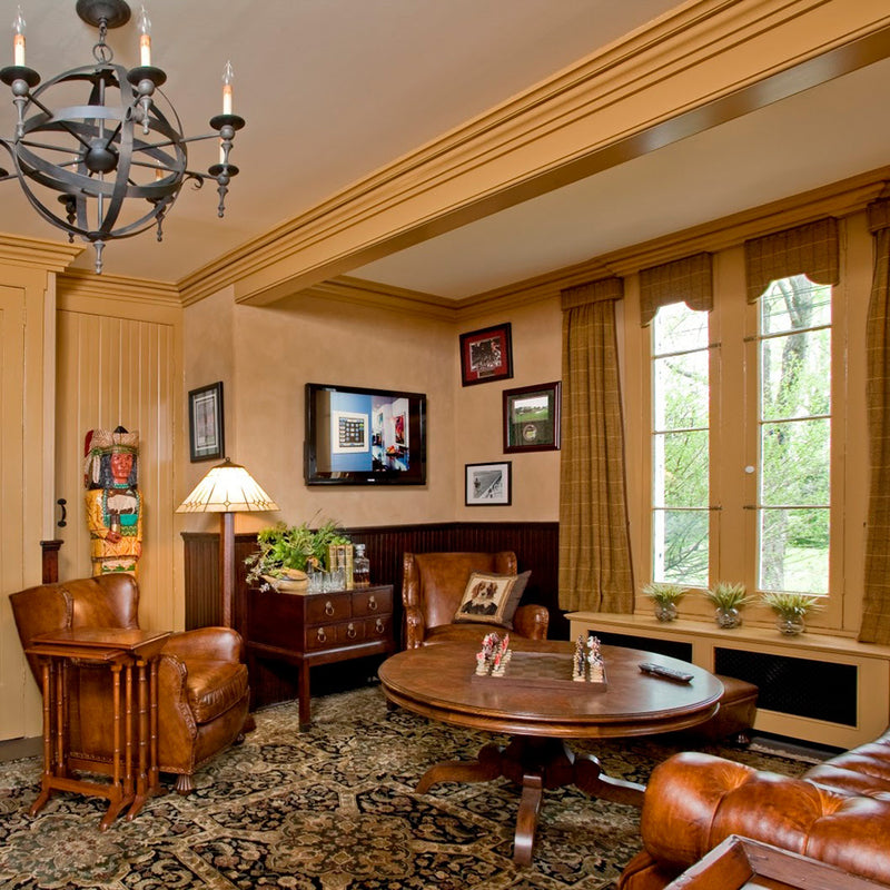 Bucks County game room featuring hand-made oriental carpet, Hancock & Moore leather chairs and tufted leather sofa, Stickley cocktail table and custom draperies